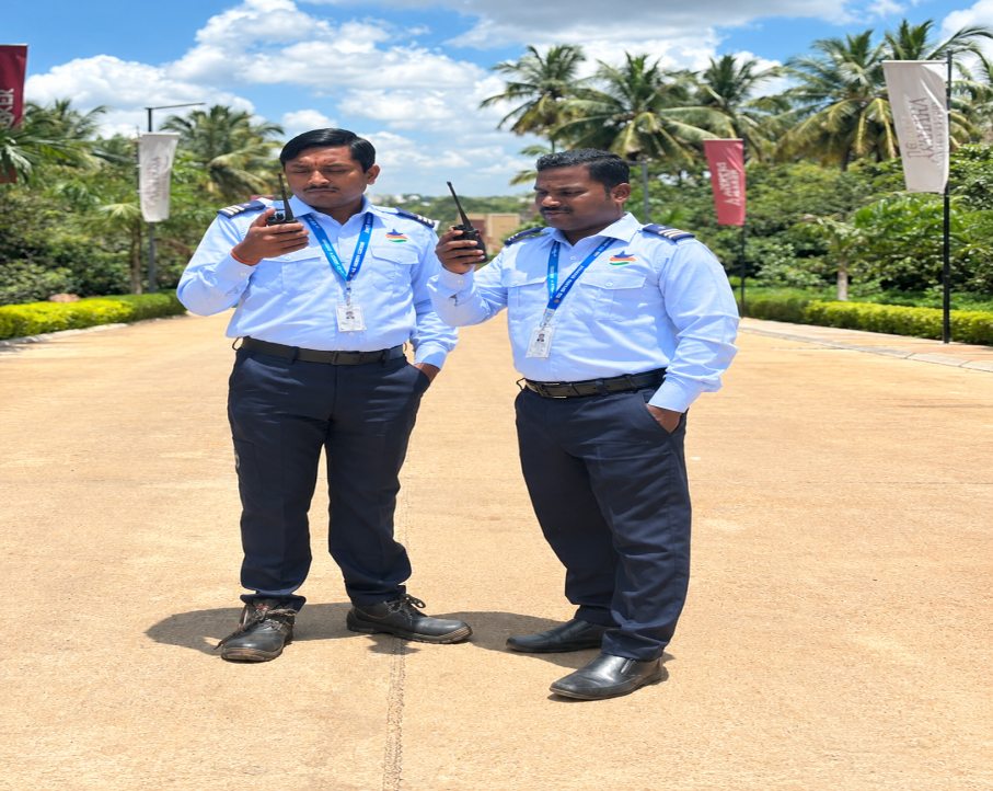 Two DB Security Services guards coordinating over walkie-talkies